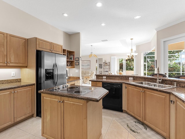 kitchen featuring sink, hanging light fixtures, a center island, light tile patterned floors, and black appliances