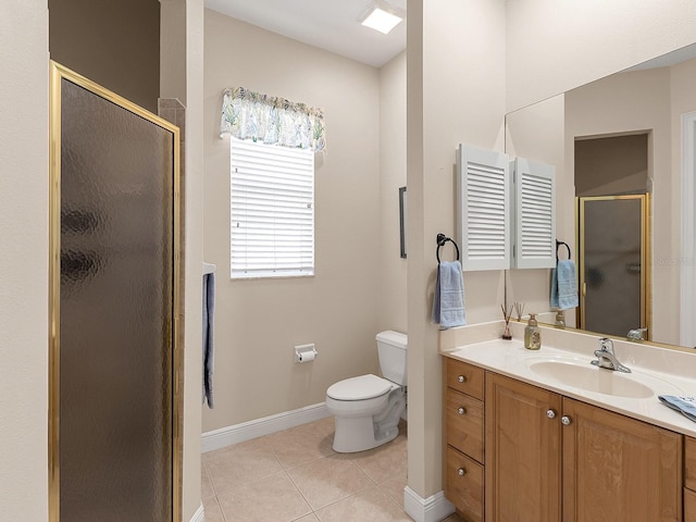 bathroom featuring tile patterned flooring, vanity, a shower with shower door, and toilet