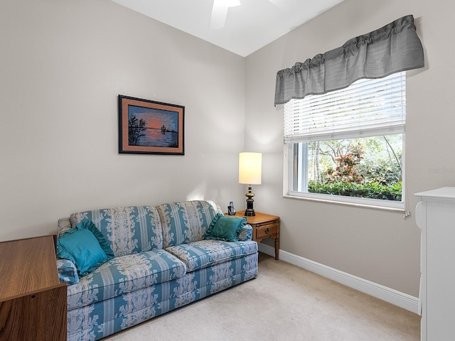 carpeted living room with ceiling fan