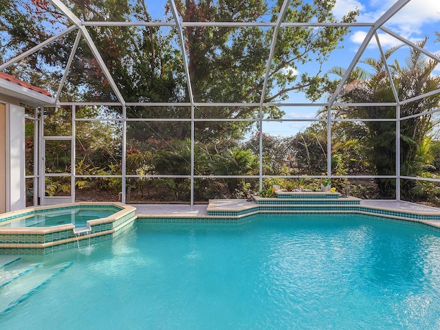 view of swimming pool with glass enclosure and an in ground hot tub