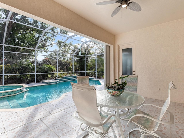 view of pool with an in ground hot tub, a lanai, pool water feature, ceiling fan, and a patio area