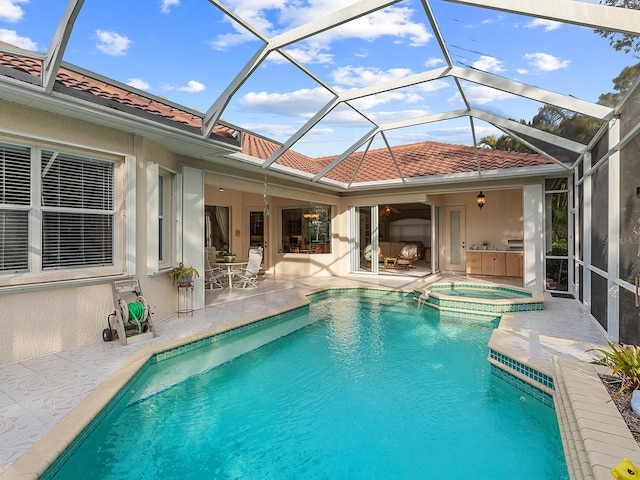 view of swimming pool featuring an in ground hot tub, glass enclosure, and a patio area