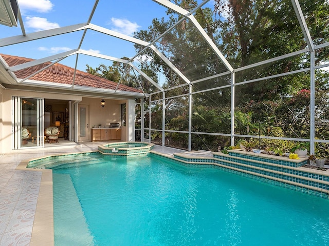 view of pool featuring an in ground hot tub, a lanai, and a patio