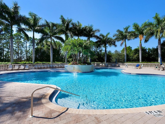 view of pool with pool water feature and a patio area