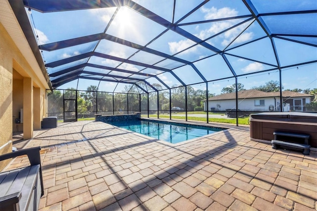 pool with a patio, a lanai, and a hot tub