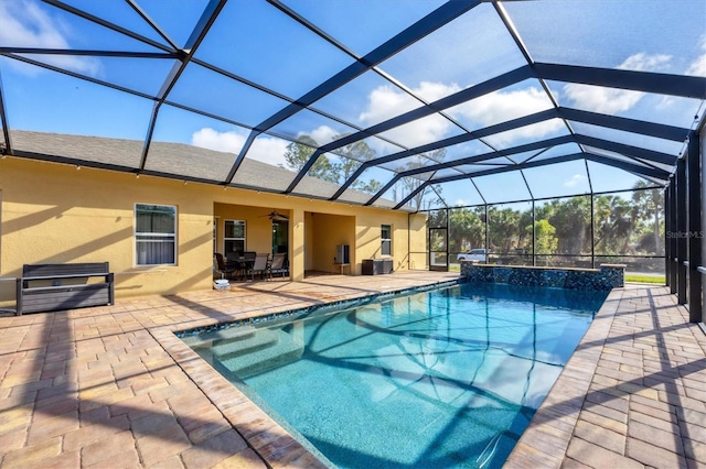 pool with a lanai, a patio, and ceiling fan