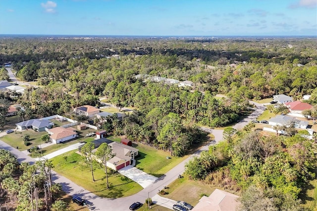 drone / aerial view with a residential view and a forest view