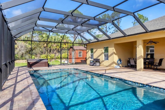 outdoor pool with a ceiling fan, a lanai, a patio area, and a hot tub