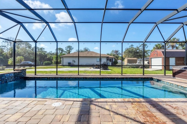 pool with a lanai, a yard, a patio, and an outbuilding