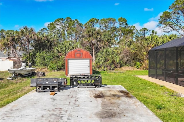 view of patio / terrace with a lanai, a storage shed, and an outdoor structure