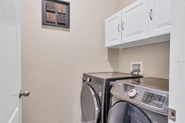 clothes washing area with cabinet space and independent washer and dryer