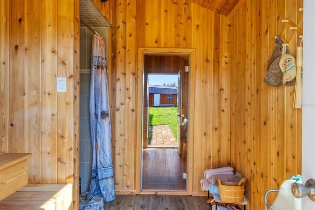 interior space featuring wooden walls and wood finished floors