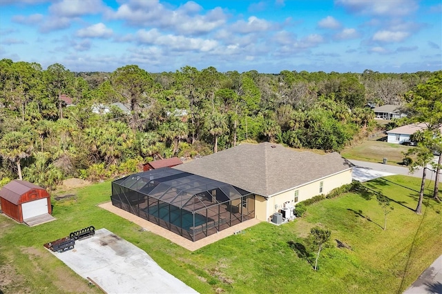 drone / aerial view featuring a view of trees