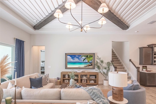 living room with an inviting chandelier, beam ceiling, and light hardwood / wood-style floors