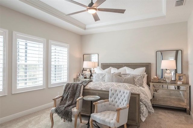 carpeted bedroom featuring ornamental molding, a raised ceiling, and ceiling fan