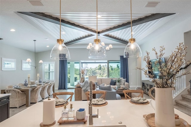 dining room featuring lofted ceiling with beams and a wealth of natural light