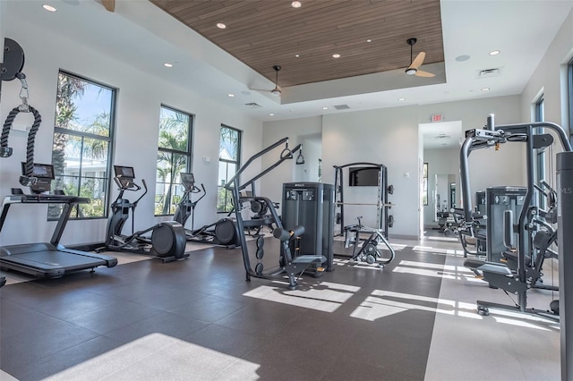 workout area featuring a raised ceiling, a towering ceiling, and wood ceiling