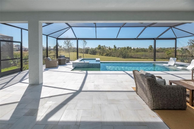 view of swimming pool featuring an in ground hot tub, a lanai, and a patio area