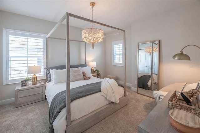 bedroom featuring carpet and a chandelier