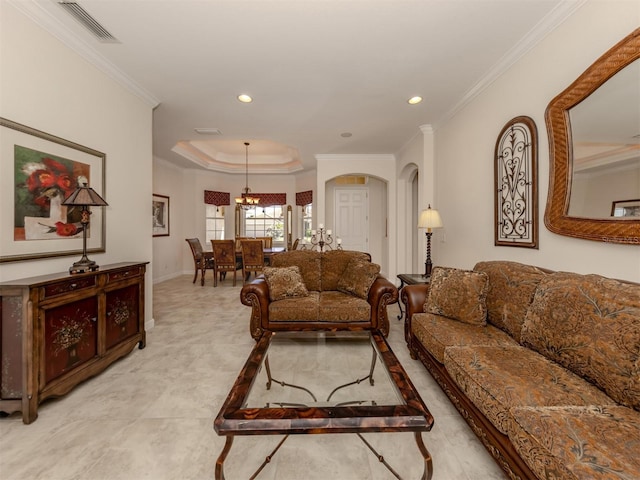 living room featuring a tray ceiling and crown molding