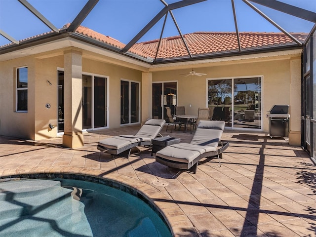 back of house with ceiling fan and a patio