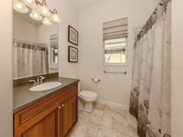 bathroom with tile patterned flooring, vanity, walk in shower, and toilet