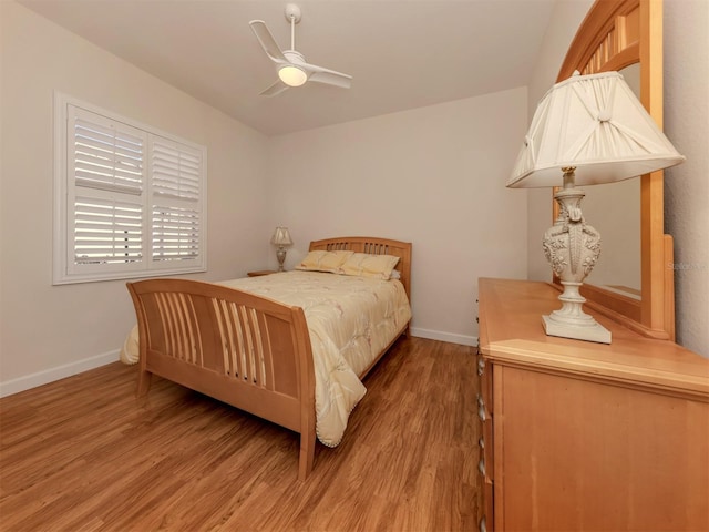 bedroom with wood-type flooring and ceiling fan