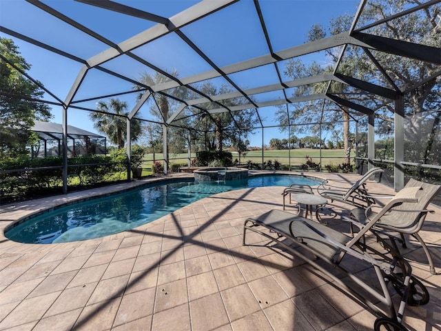 view of swimming pool with an in ground hot tub, a patio, and glass enclosure