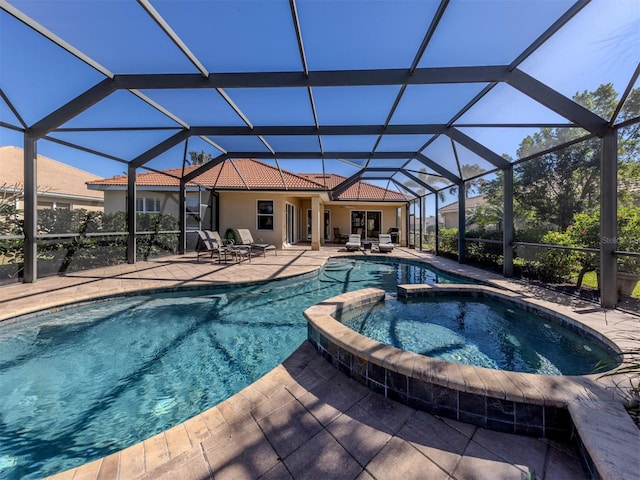 view of pool with a lanai, a patio, and an in ground hot tub