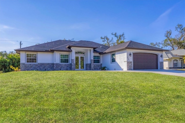 view of front of house with french doors, a garage, and a front lawn