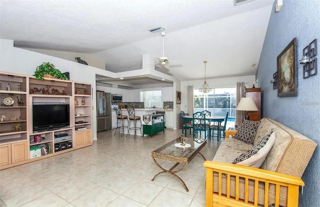 living room featuring lofted ceiling, a textured ceiling, and ceiling fan