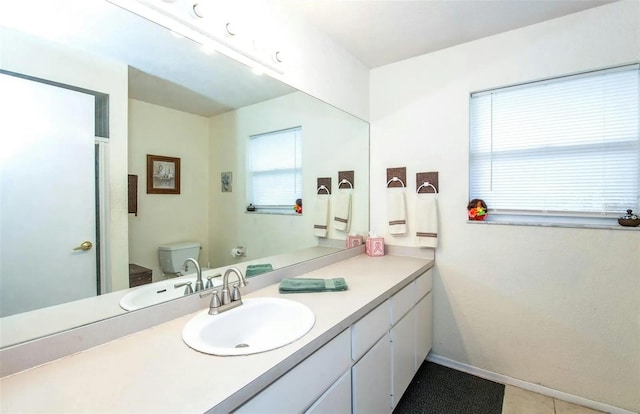 bathroom featuring vanity and toilet