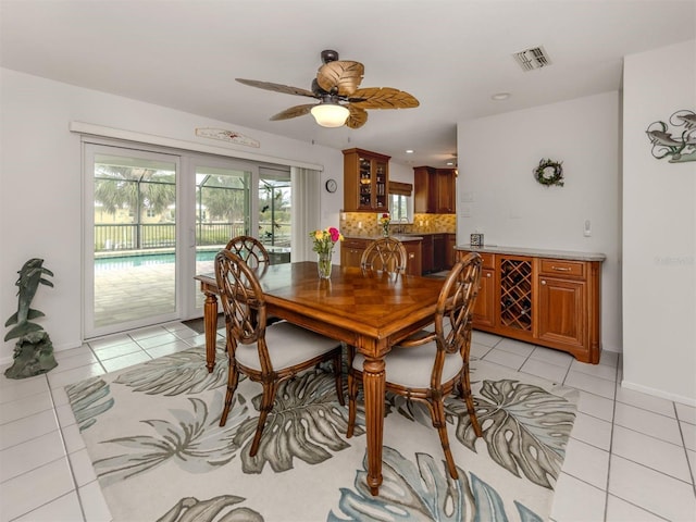 tiled dining room with ceiling fan