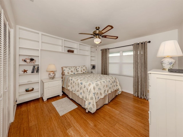 bedroom with ceiling fan and light hardwood / wood-style flooring