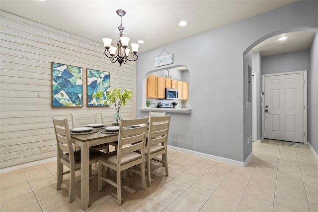 dining space with a chandelier and light tile patterned flooring