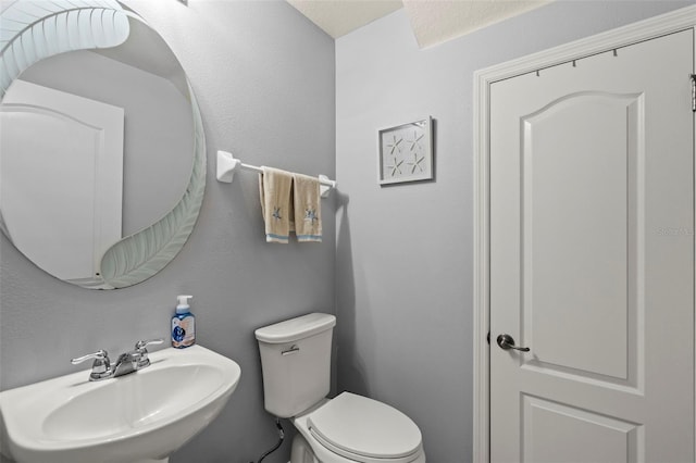 bathroom featuring sink and toilet