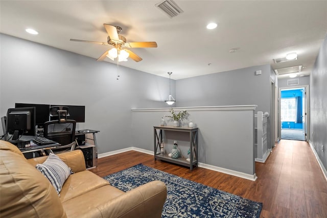 living room with wood-type flooring and ceiling fan