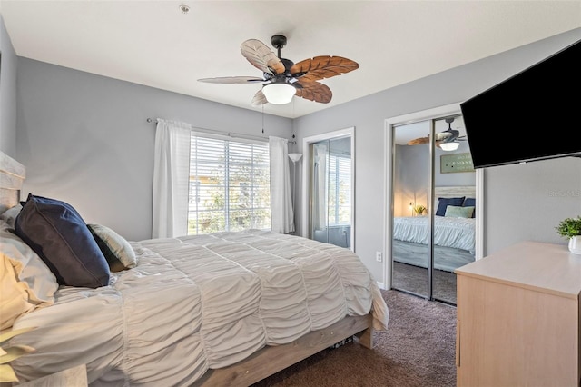 bedroom with access to exterior, two closets, ceiling fan, and dark colored carpet