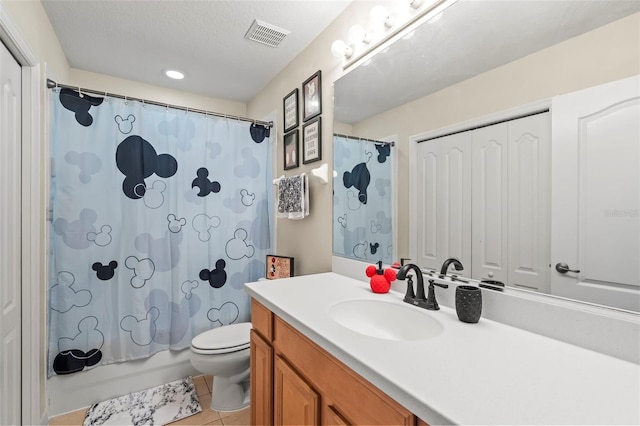 full bathroom with shower / tub combo with curtain, vanity, a textured ceiling, tile patterned floors, and toilet