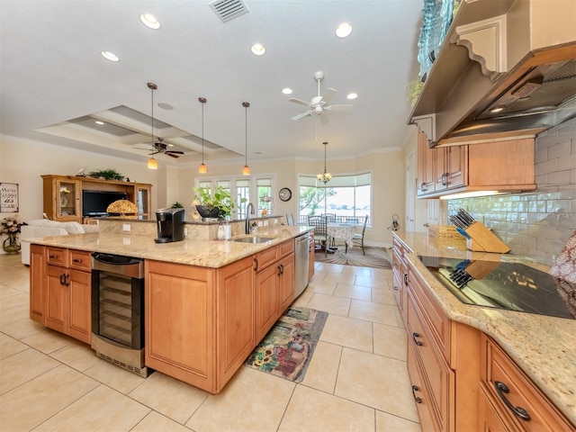 kitchen featuring pendant lighting, sink, wine cooler, custom exhaust hood, and light stone countertops