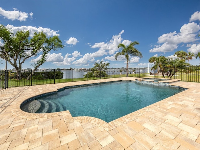 view of pool with an in ground hot tub, a water view, and a patio area