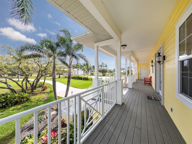 deck with a yard and covered porch