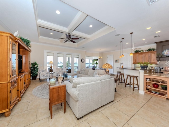 living room with light tile patterned flooring, ceiling fan with notable chandelier, coffered ceiling, crown molding, and beam ceiling