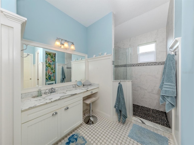 bathroom with vanity and tiled shower