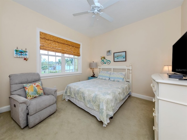 bedroom featuring light colored carpet and ceiling fan