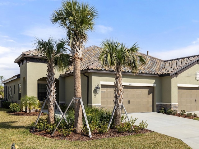 mediterranean / spanish-style home with a garage and a front lawn