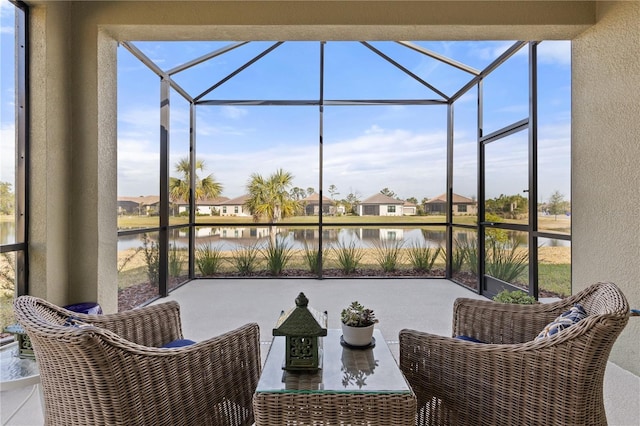 sunroom featuring a healthy amount of sunlight and a water view