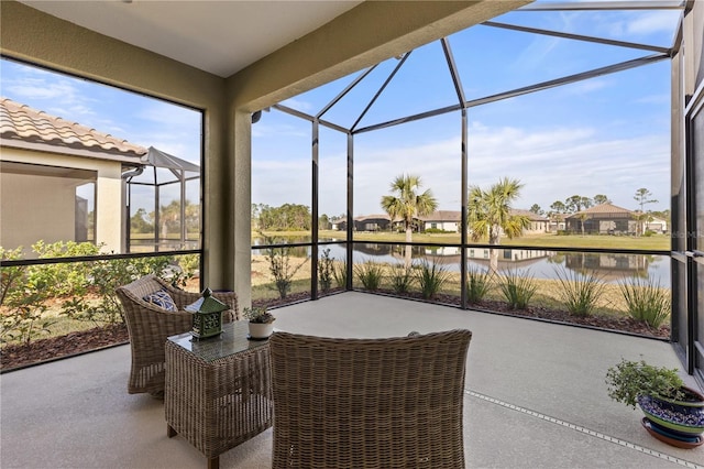 sunroom / solarium featuring a water view