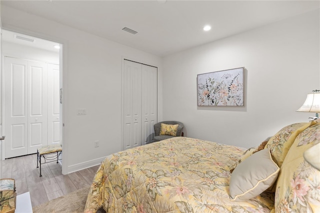 bedroom featuring light hardwood / wood-style floors and a closet