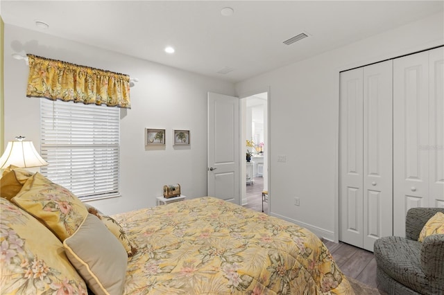 bedroom featuring hardwood / wood-style floors and a closet